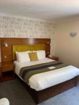 Contents of guest bedroom number 22 at the Brookfield Hotel. Darkwood bedroom desk with 3 drawers