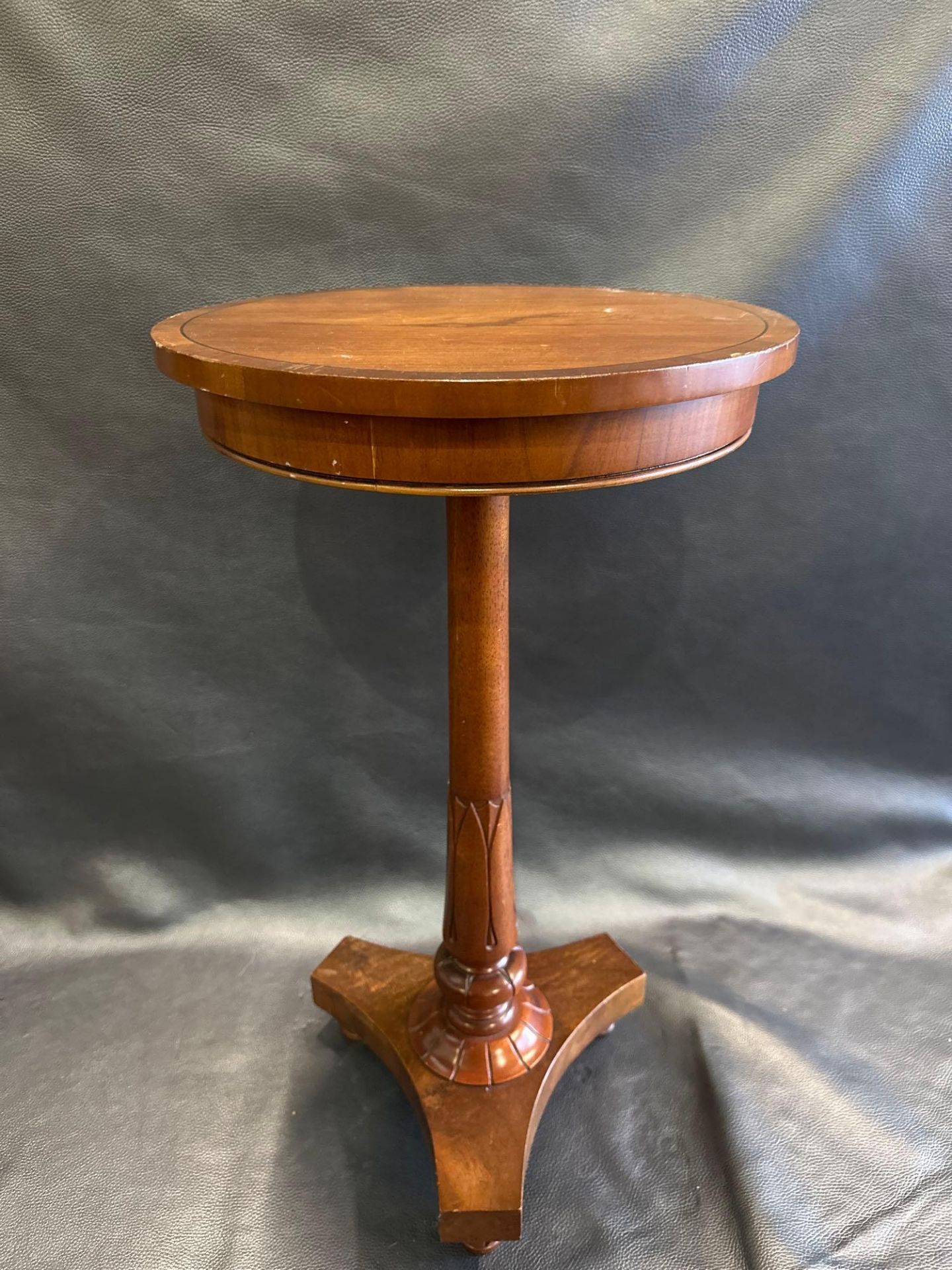 A Mahogany Pedestal Lamp Table The Circular Top Raised On A Carved Pedestal With Triform Base 40 x