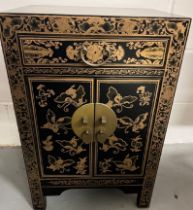 Chinese Lacquered Side Cabinet The cabinet has figurative panels on the front in lacquered gold