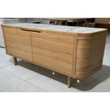 The Asher Sideboard combines a solid walnut frame with Italian Carrara marble to produce a