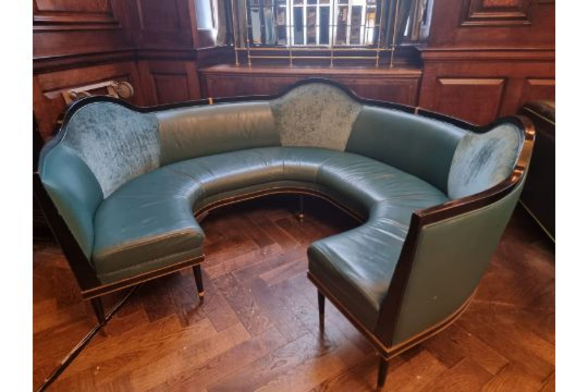 A bespoke Robert Angell tufted leather banquette upholstered  Circular Banquette Bench On Carved