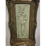 A Framed Stone Plaque Depicting  In Relief A Nymph And A Winged Fairy Framed, In A Green Hue