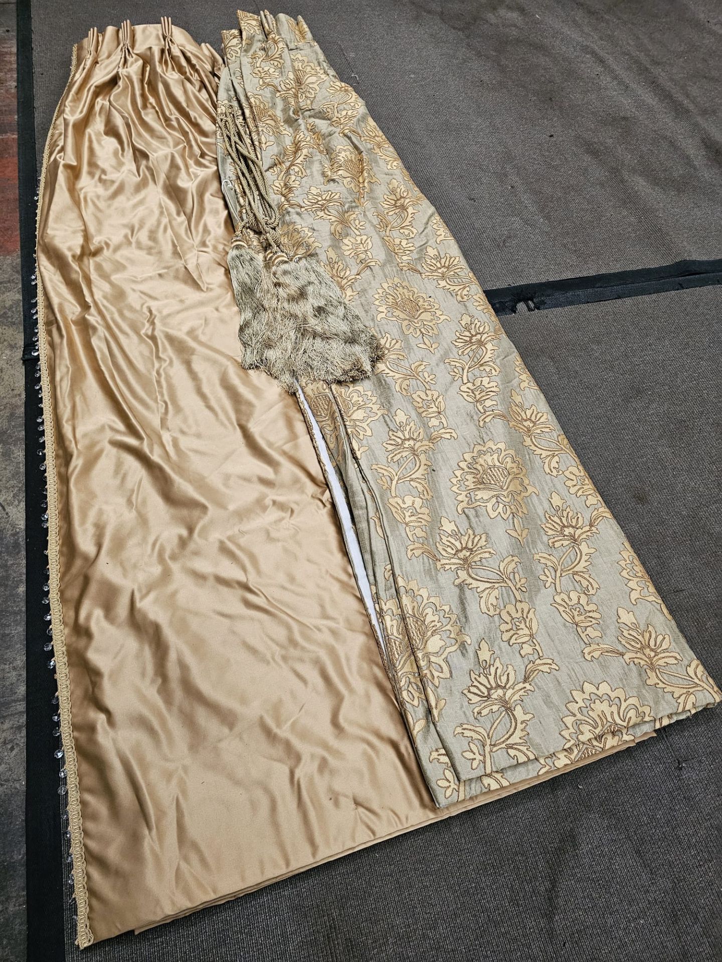 A pair of silk drapes and jabots gold with crystal trim and  embroidered iwith gold silver pattern