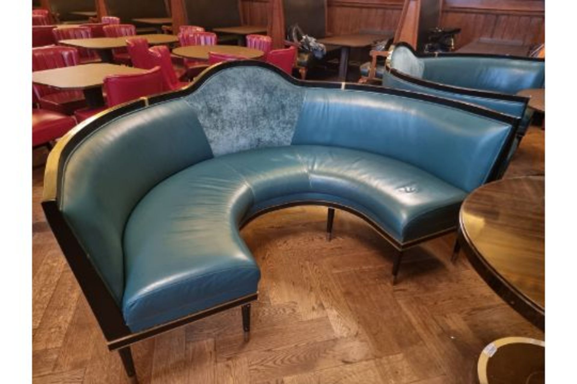 A  bespoke Robert Angell tufted leather banquette upholstered Circular Banquette Bench On Spindle