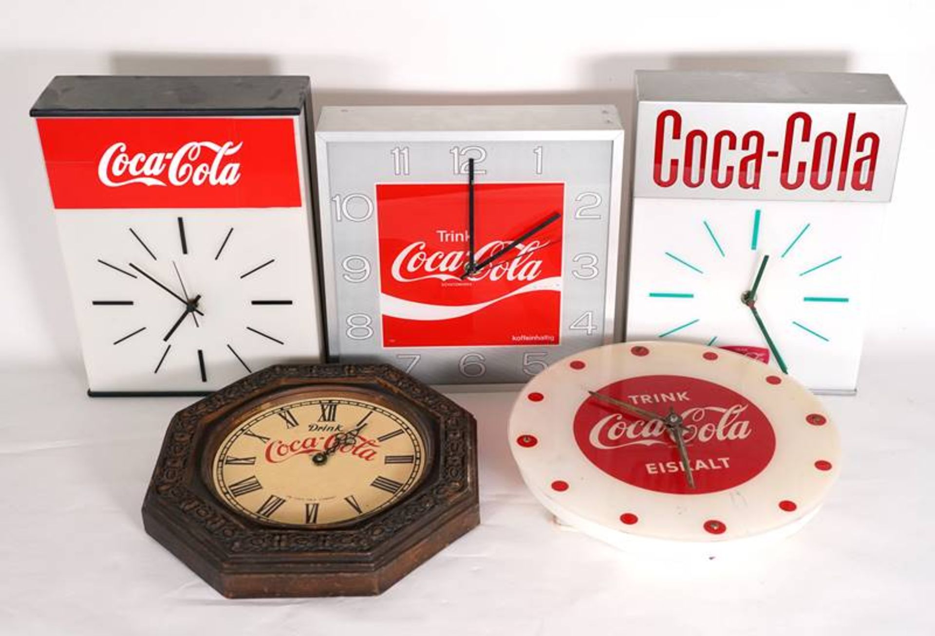 Five Coca-Cola advertising clocks
