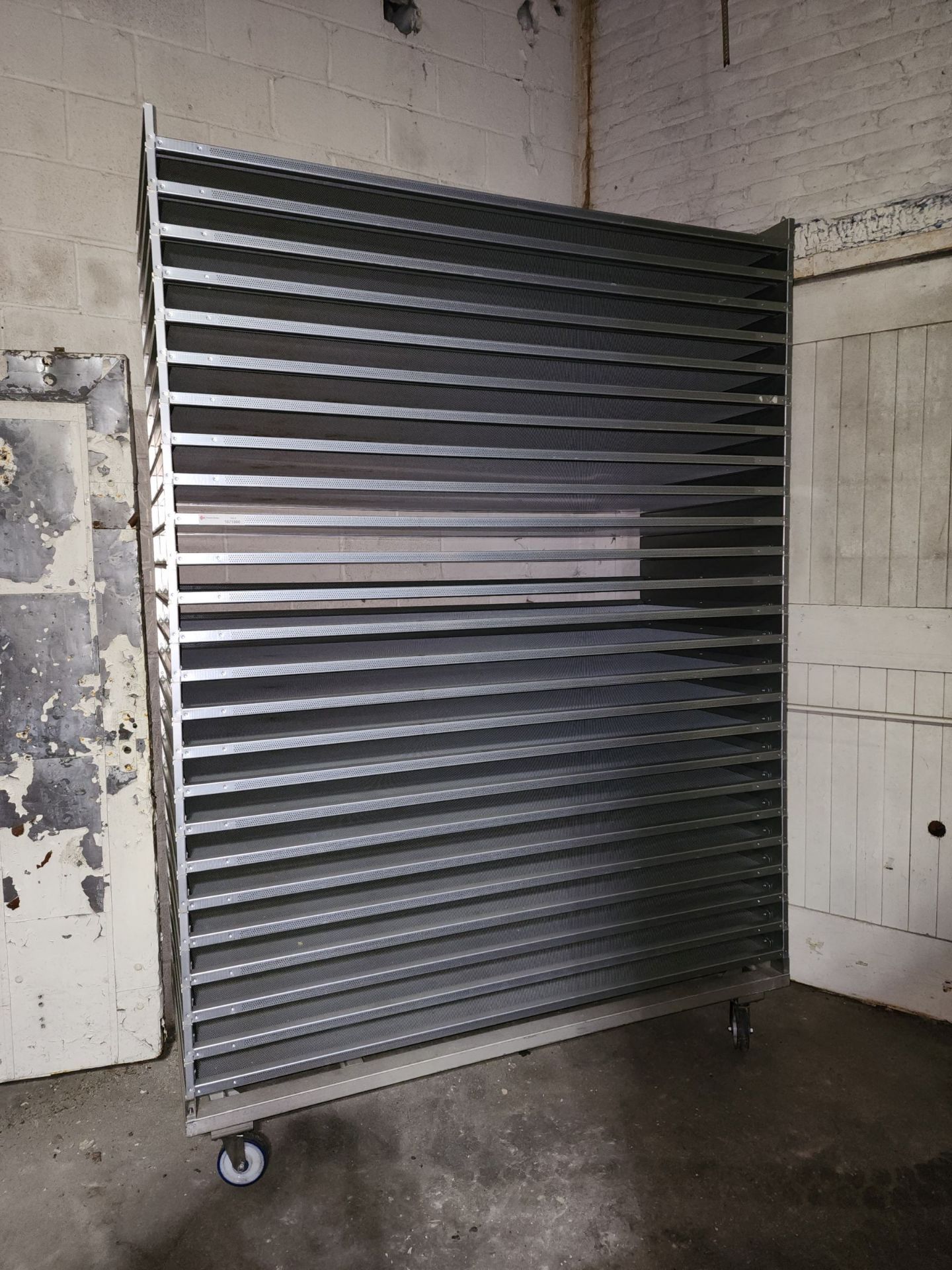 Stack of (25) Aluminum Trays, perforated, on Transport cart