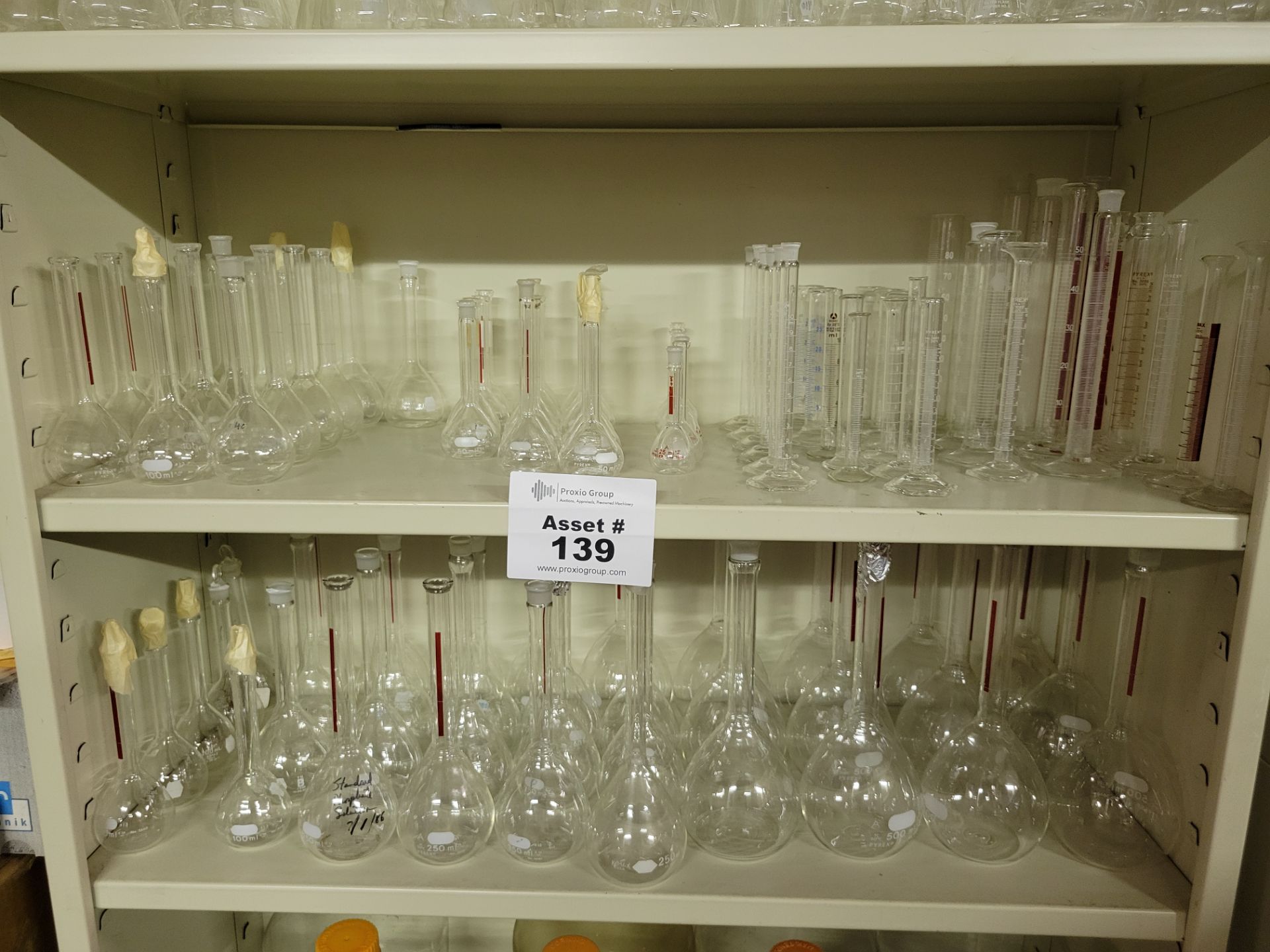 (2) Shelves of Various Sized and Manufacturer Glass Erlenmeyer Flasks Sizes Range From 25 to500mL