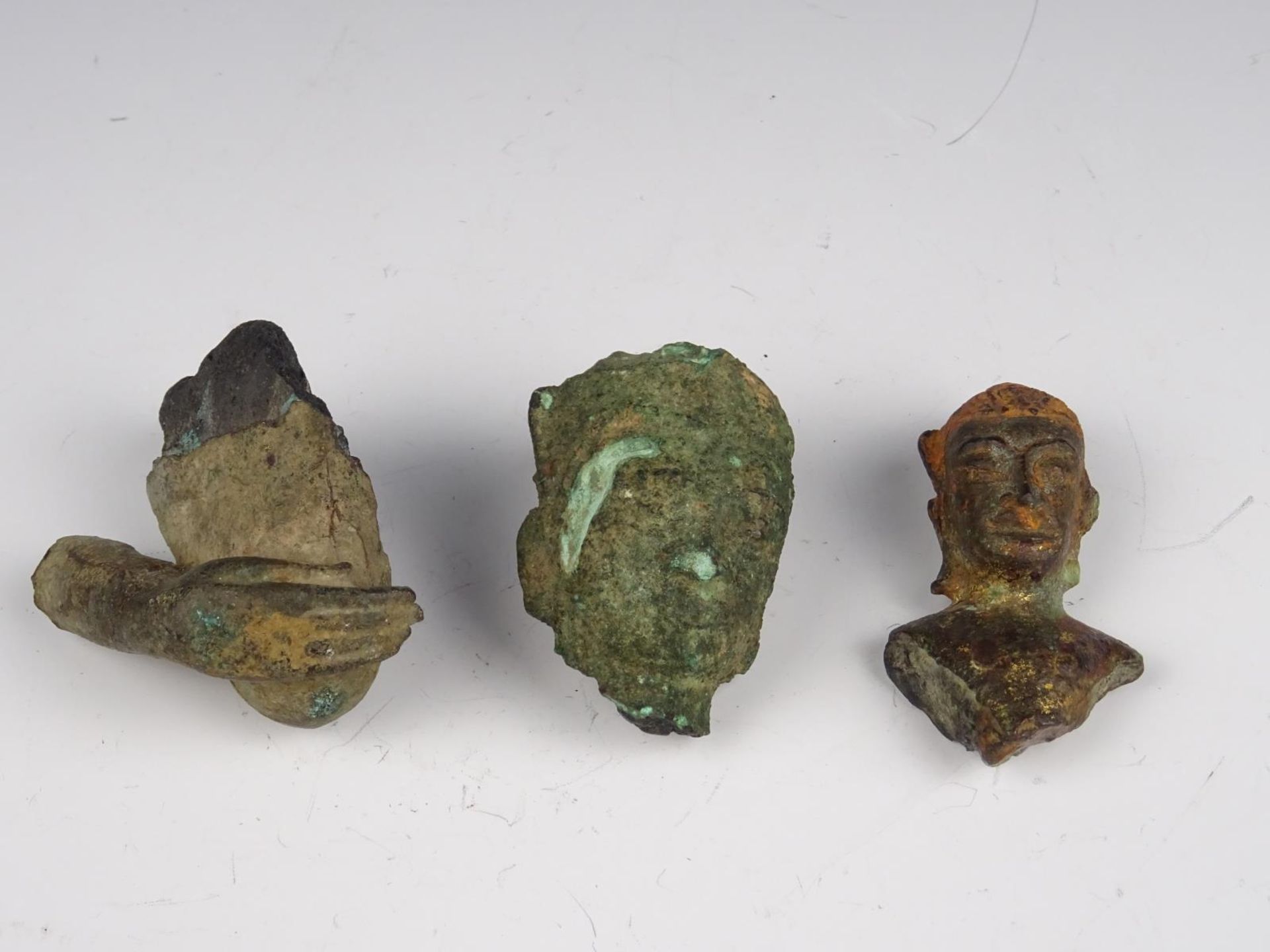 Three bronze buddha heads