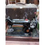 AN ELECTRIC SINGER SEWING MACHINE WITH CASE