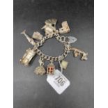 SILVER CHARM BRACELET WITH VARIOUS CHARMS,