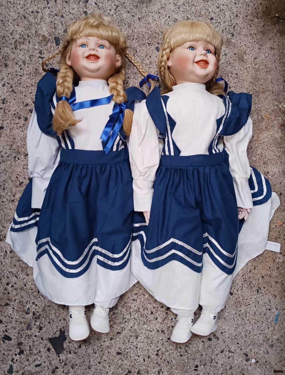 2 LARGE DOLLS DRESSED IN BLUE & WHITE UNIFORM STYLE DRESSES