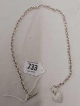 A SILVER NECK CHAIN WITH HEART SHAPED PENDANT