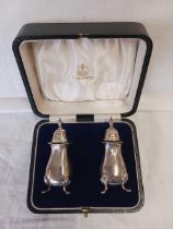 A PAIR OF BOXED SILVER PEPPERS BY E & CO,