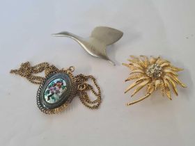 AN ENAMELED DECORATED LOCKET ON CHAIN & 2 BROOCHES