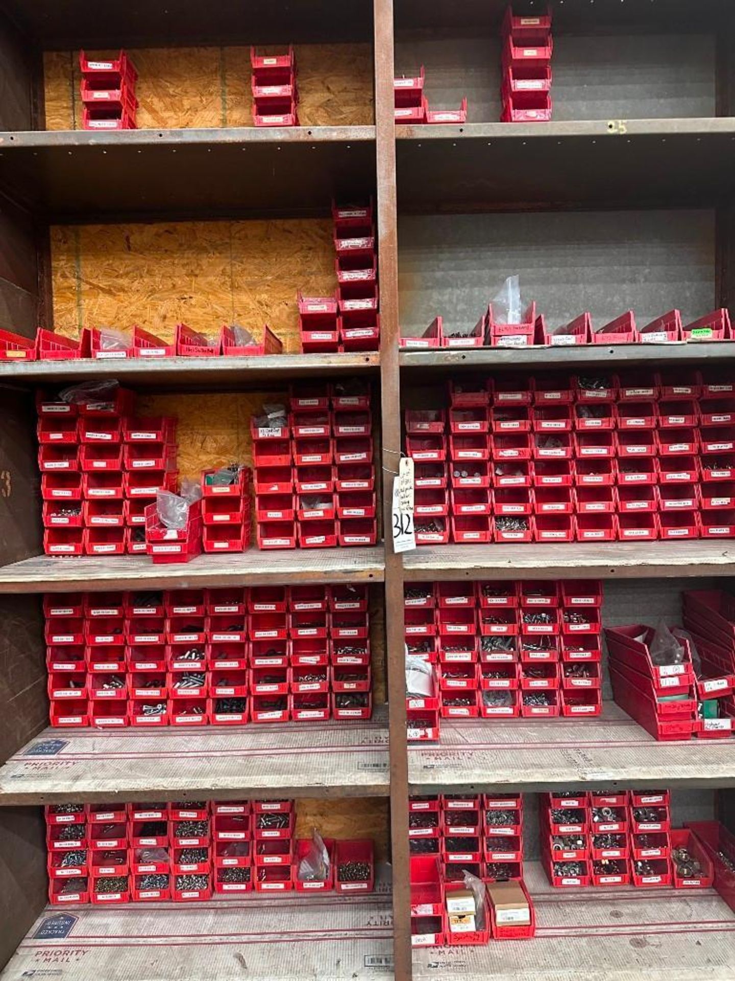 LOT OF RED BINS FULL OF SORTED HARDWARE