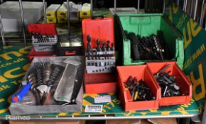 Multiple drill bits of assorted types and sizes plus drill chuck keys