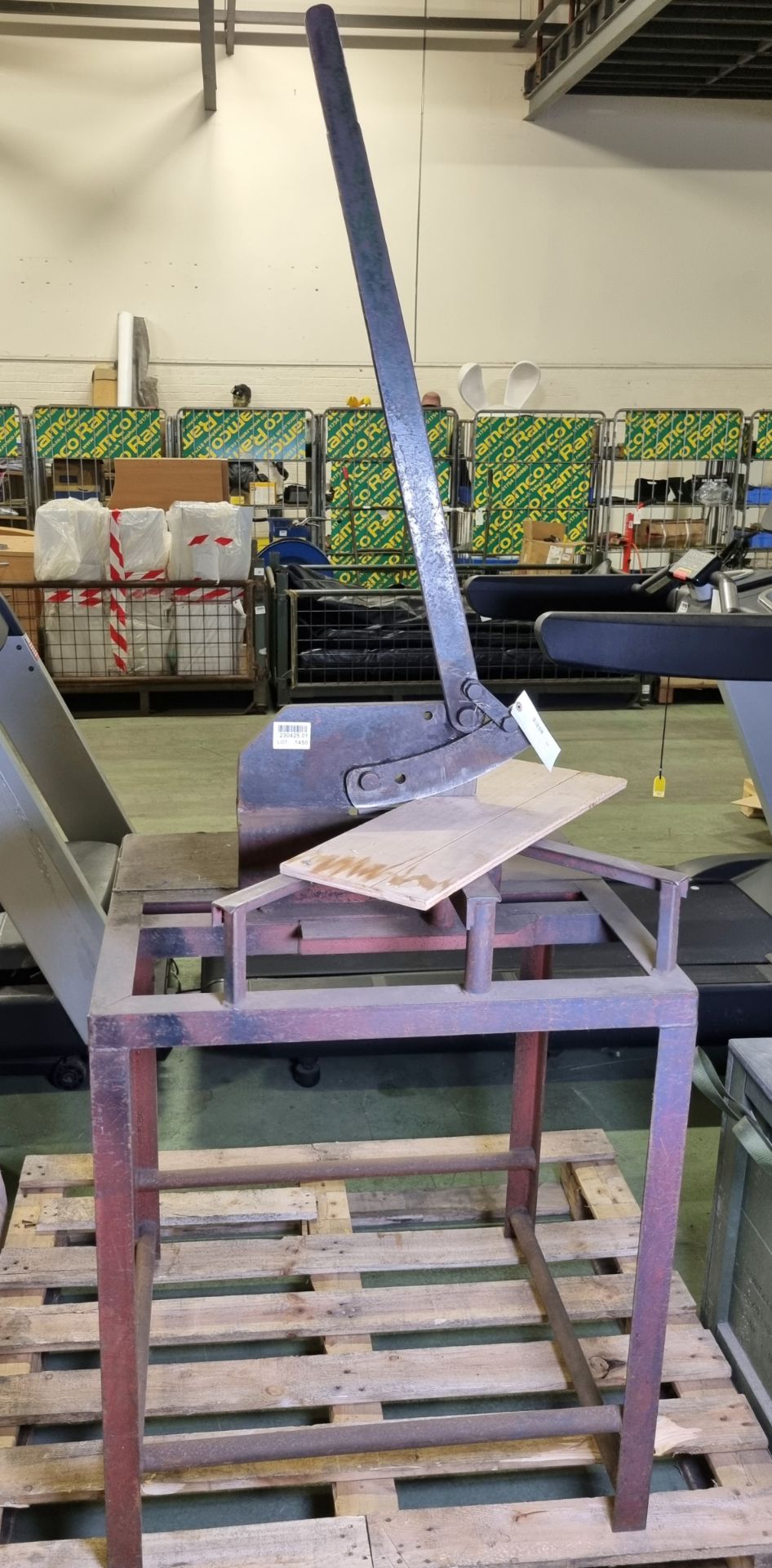 Manual metal cutter on steel work frame
