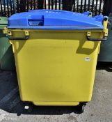 Large yellow plastic wheelie bin with blue lid - L 1200 x W 1000 x H 1300mm