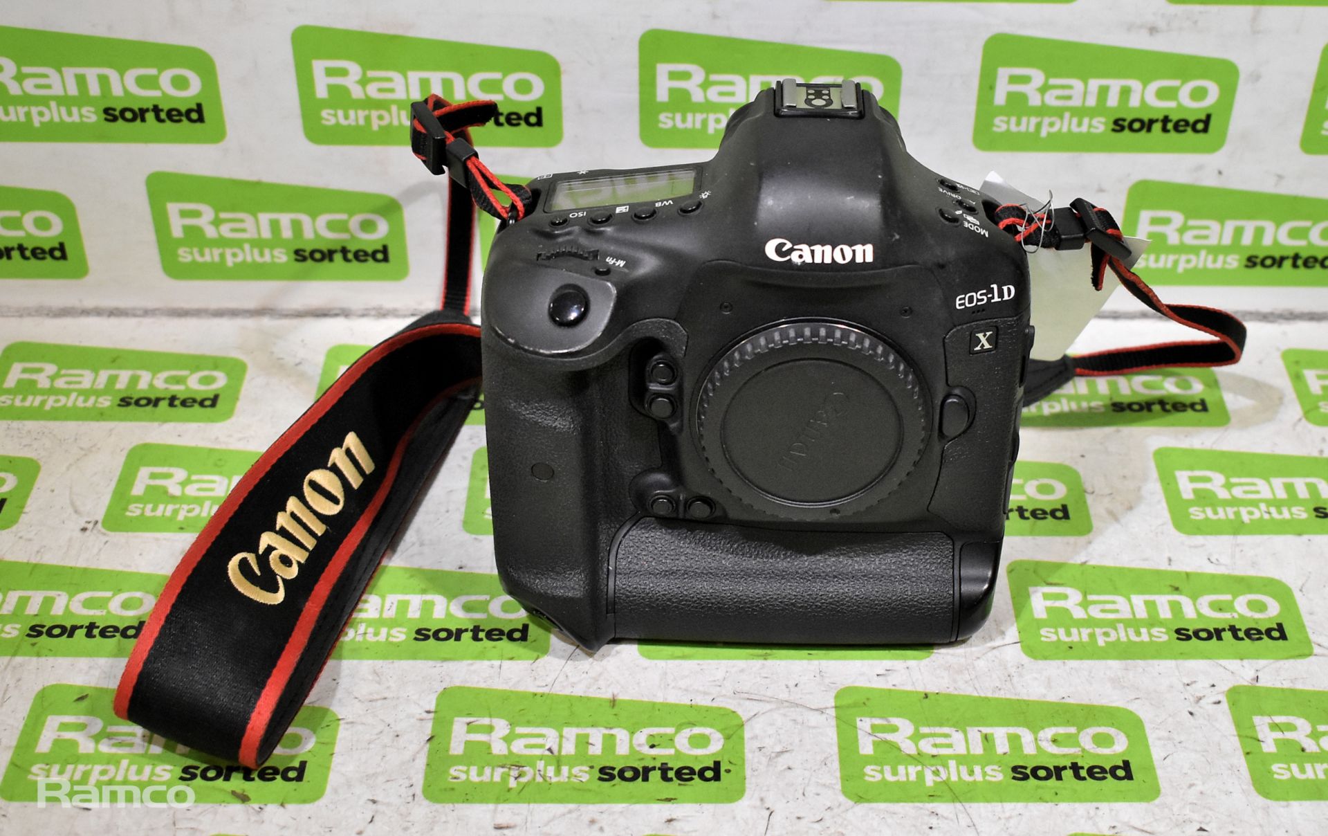 Canon EOS-1DX DSLR camera with battery and strap
