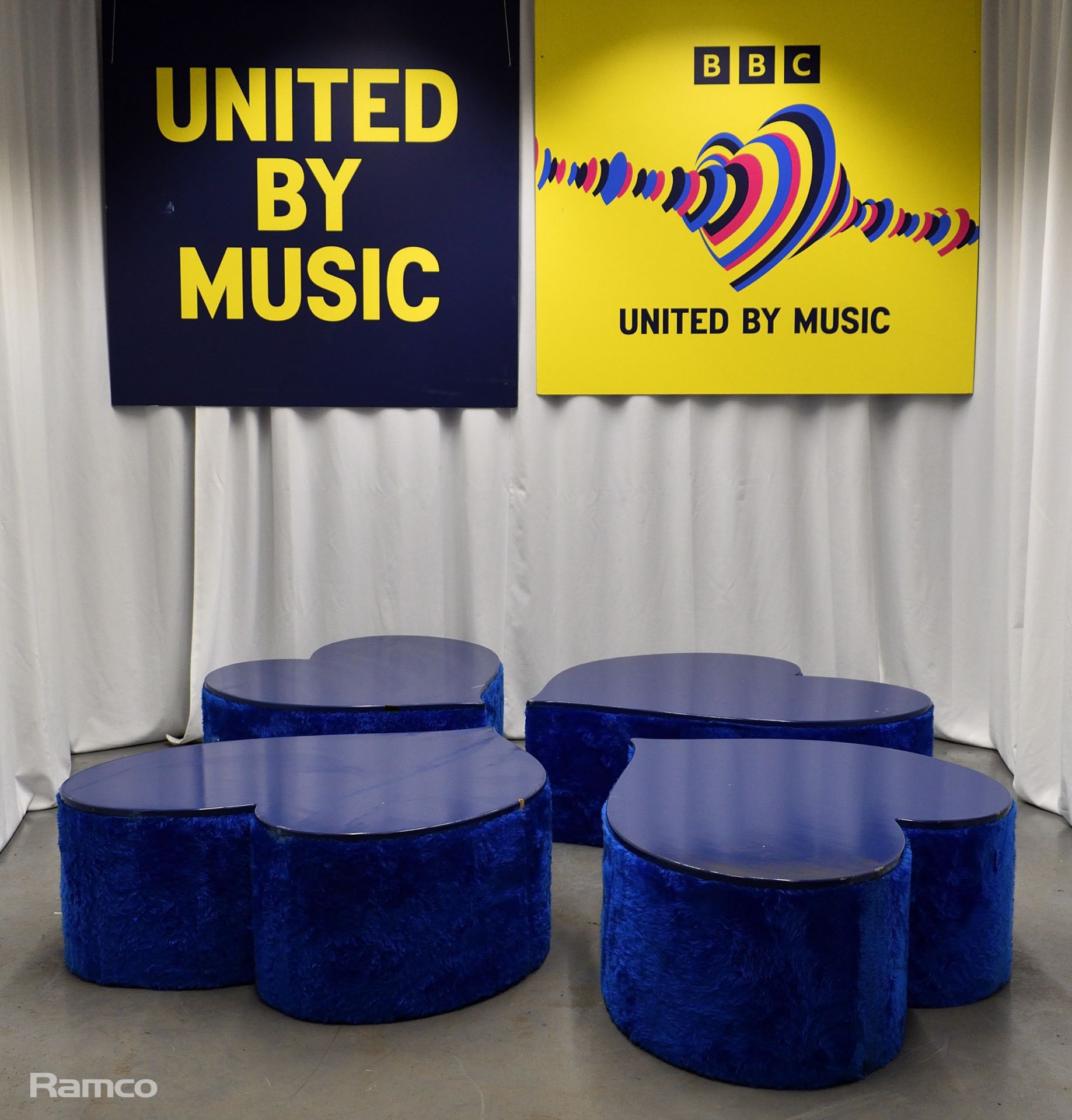 4x Asymmetrical heart shaped blue fur-covered wooden tables from countries' seating area