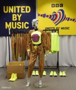 Gold Outfits worn by backing dancers during the performance by Netta of 'You Spin Me Round'
