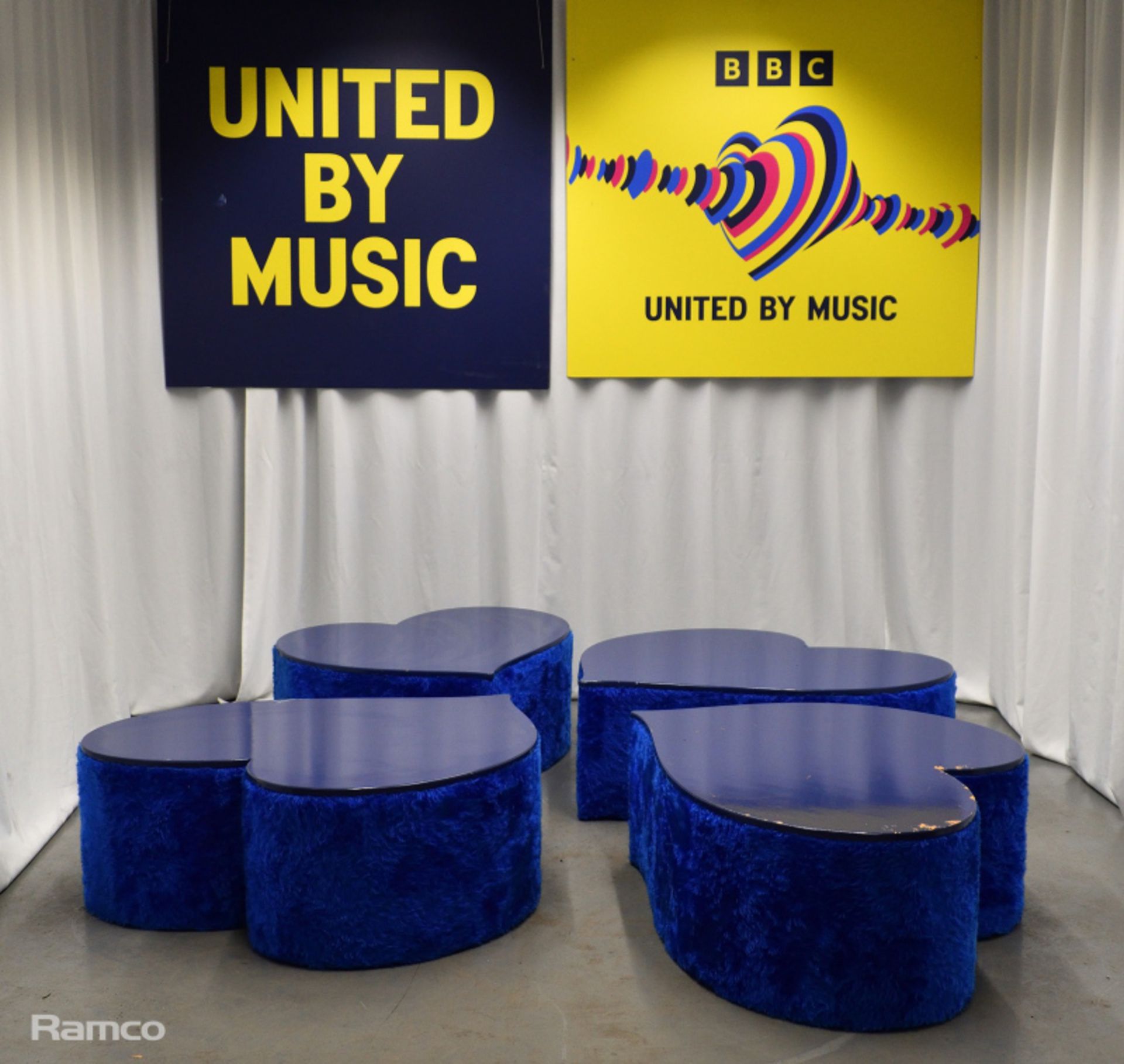 4x Asymmetrical heart shaped blue fur-covered wooden tables from countries' seating areas