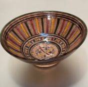 A Safi pottery bowl decorated with handpainted linear and scroll centre banded design, signed verso,