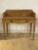 A Victorian pine wash stand, the raised back over two frieze drawers, raised on turned supports,