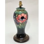 A Moorcroft pottery baluster vase lamp with green ground and tube lined anemone design raised on