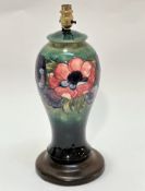 A Moorcroft pottery baluster vase lamp with green ground and tube lined anemone design raised on