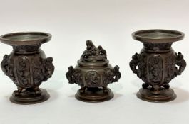 A Chinese bronze late 19thc garniture set including a pair of baluster vases raised on tripod