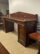 A mid 19th century mahogany twin pedestal serving table, the arched raised back over top fitted with