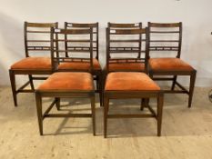 A set of six Regency mahogany dining chairs, with reeded uprights and rail backs, drop in