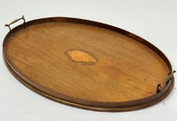 An Edwardian mahogany oval twin brass handled gallery tea tray with shell inlaid centre oval