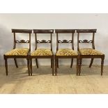 A set of four Regency mahogany dining chairs, with beaded moulding to the crest rail over shell