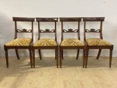 A set of four Regency mahogany dining chairs, with beaded moulding to the crest rail over shell