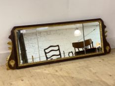 A 1930's parcel gilt walnut framed sectional bevelled glazed mirror of 18th century design, 126cm