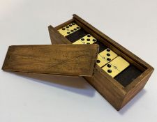 A treen box containing a set of dominoes