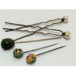 An Edwardian copper enamelled scarab mounted stick pin, (1 x 1), a jeweled enamelled pin, two