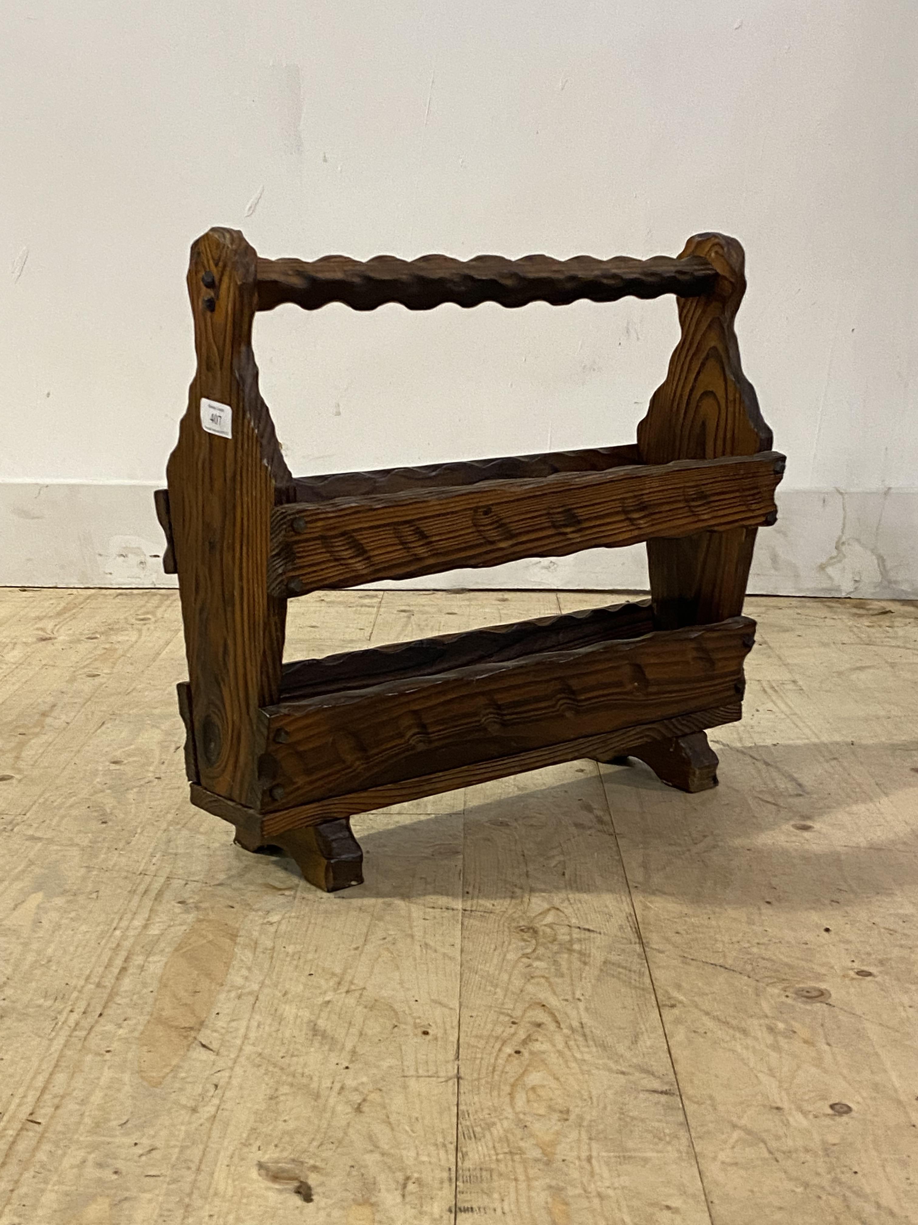 A late 20th century Spanish pitch pine magazine rack, H45cm, W49cm