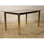 A vintage post modern dining table, circa 1970's, the rectangular glass top raised on gilt and