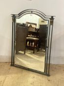 A cast and wrought metal wall hanging mirror, the arched bevelled plate enclosed by frame finished