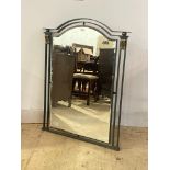 A cast and wrought metal wall hanging mirror, the arched bevelled plate enclosed by frame finished