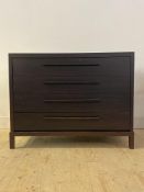 A contemporary stained oak veneered chest, fitted with four drawers, raised on square section