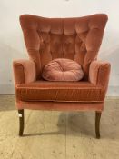 An early to mid 20th century lounge chair, upholstered in deep buttoned red velvet, raised on