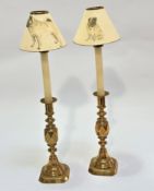 A pair of Victorian cast brass Queen of Diamonds candlesticks raised on baluster knop turned stems