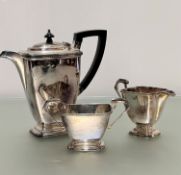 An Epns three piece tea service of rectangular tapered form with black handle to side and knop, (