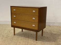 A mid century teak veneered chest, fitted with three drawers, raised on turned supports, H75cm,