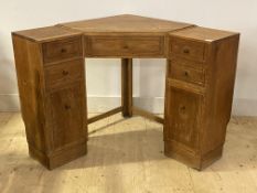 Heals, an oak corner writing desk, early 20th century, fitted with one long and four short