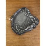 A WMF Pewter tray of Art Nouveau design, moulded as a lady reclining against a harp, with